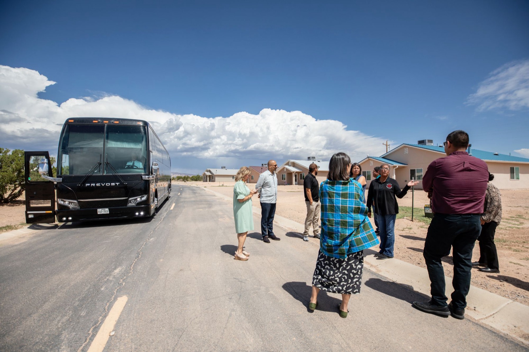 Roundtable partners step off a tour bus at a Tribal housing development during the New Mexico site visit